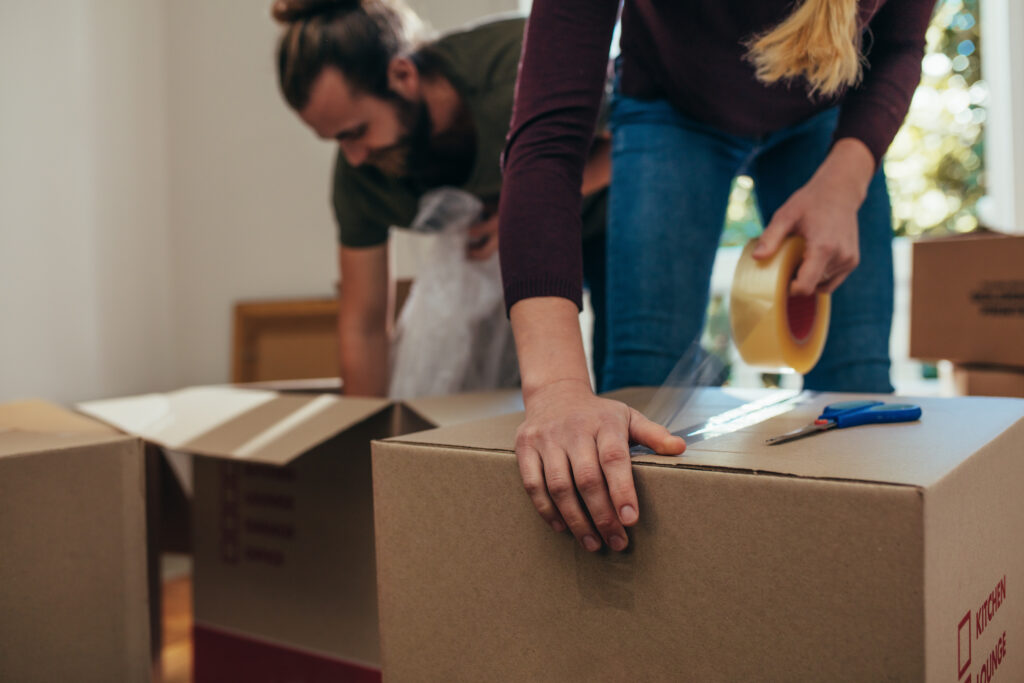 Professional packer taping a moving box — packing service Harrogate