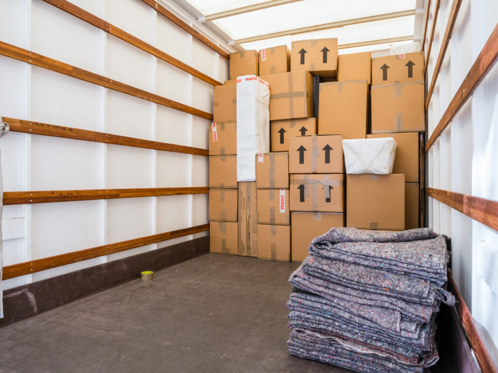 Inside a removal van with protective blankets and boxes — storage service